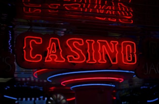 Neon lights display the word 'CASINO' in bright red, standing out against a dark background. The vibrant glow reflects a lively and bustling atmosphere.